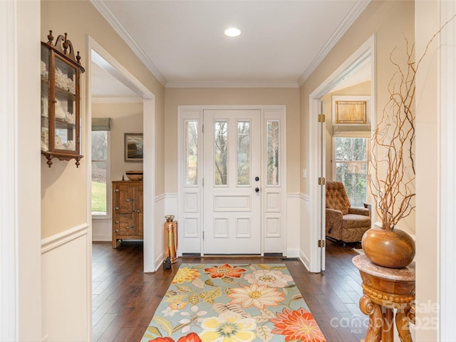 foyer entrance with dark hardwood / wood-style flooring and ornamental molding