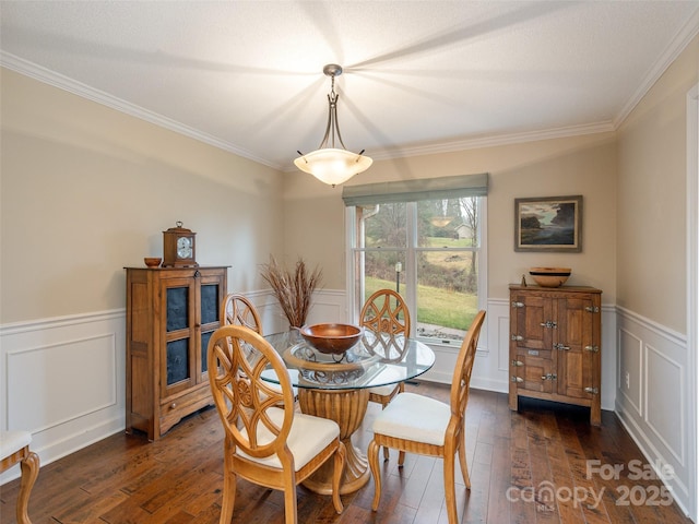 dining room featuring dark hardwood / wood-style flooring and ornamental molding