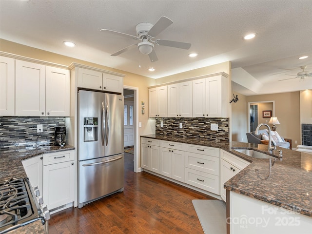 kitchen with dark stone countertops, sink, white cabinetry, and stainless steel appliances