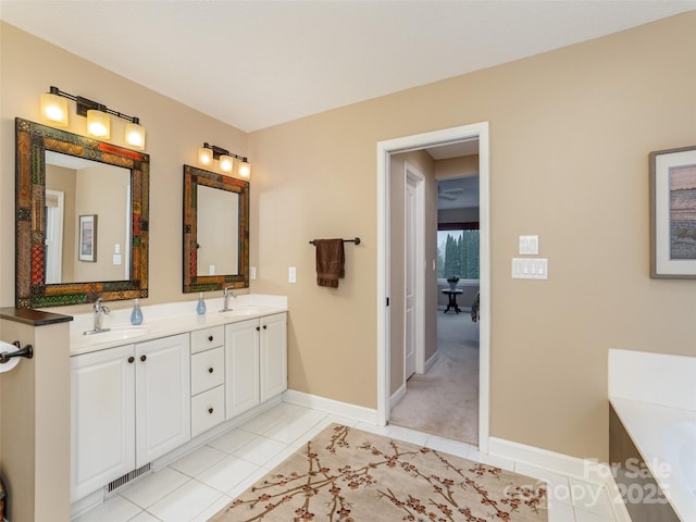 bathroom featuring tile patterned floors, a bathtub, and vanity