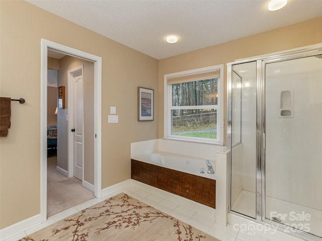 bathroom with tile patterned flooring, a textured ceiling, and separate shower and tub