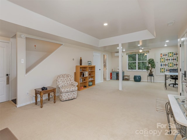 sitting room featuring carpet and a tray ceiling