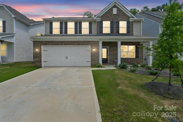 view of front of house featuring a yard and a garage