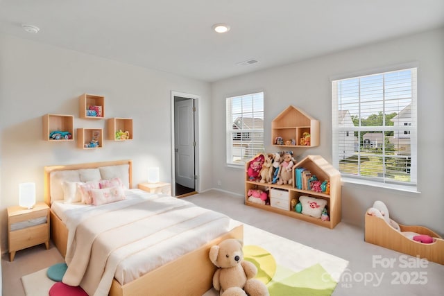 bedroom featuring light carpet