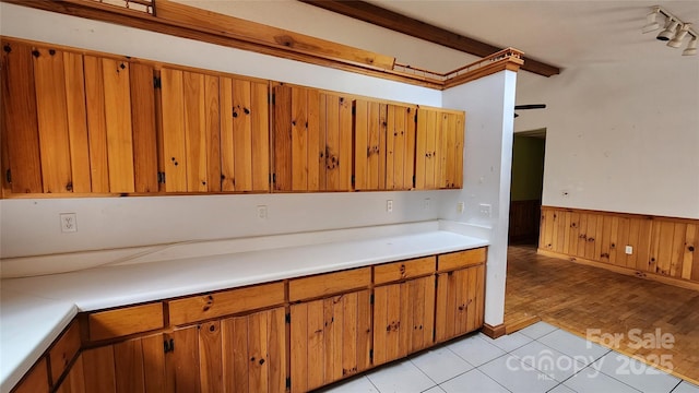 kitchen featuring beam ceiling and light tile patterned floors