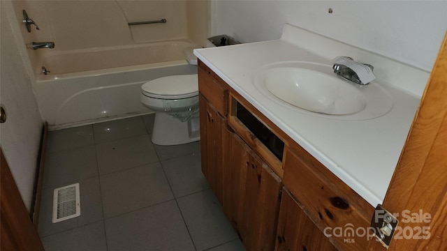 bathroom with toilet, tile patterned floors, and vanity