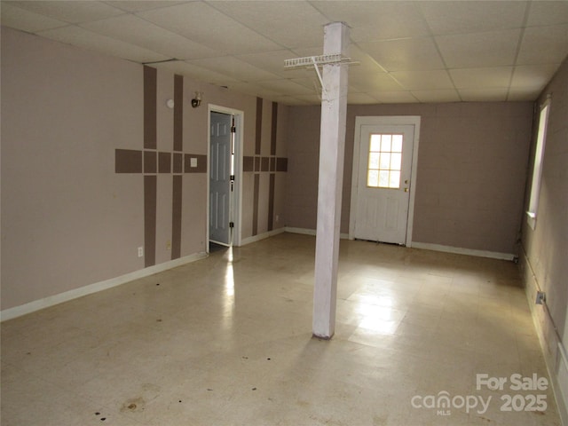 basement featuring a paneled ceiling