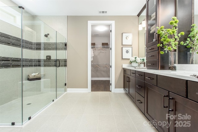 bathroom with vanity, tile patterned floors, and walk in shower