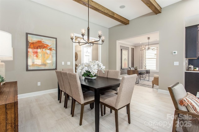 dining room featuring beam ceiling, an inviting chandelier, and light hardwood / wood-style flooring