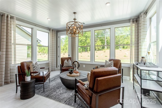 sunroom / solarium with an inviting chandelier