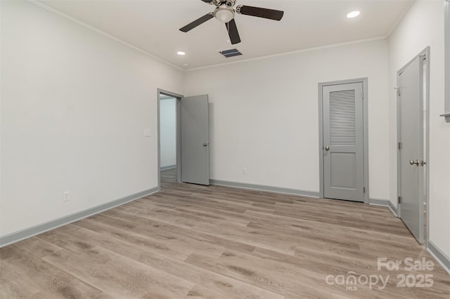 unfurnished bedroom with a closet, light hardwood / wood-style floors, ceiling fan, and crown molding