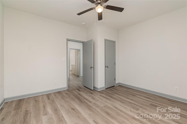 unfurnished room with ceiling fan and light hardwood / wood-style flooring