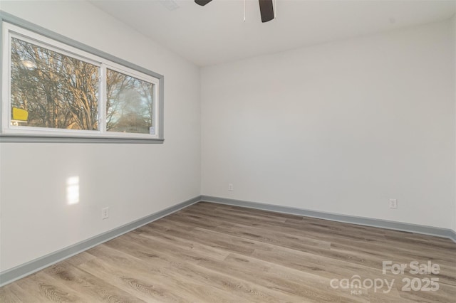 empty room featuring ceiling fan and light hardwood / wood-style flooring