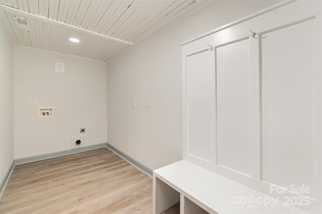 laundry room featuring hookup for a washing machine, light hardwood / wood-style floors, crown molding, and electric dryer hookup