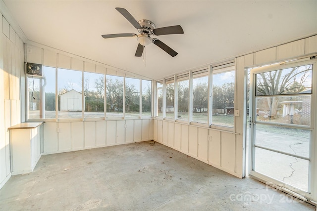 unfurnished sunroom with ceiling fan and vaulted ceiling