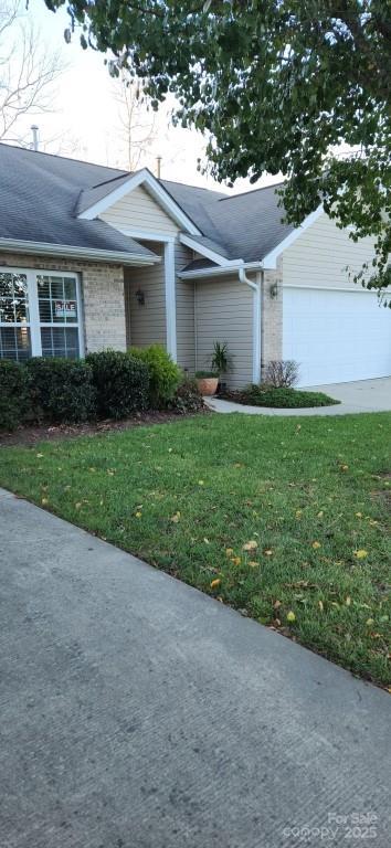 view of front of property with a front yard and a garage