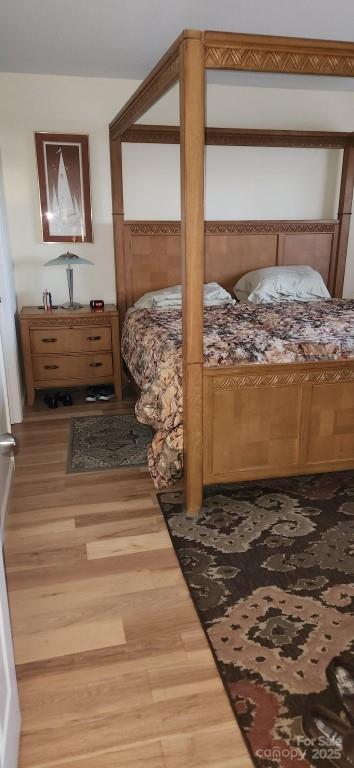 bedroom with hardwood / wood-style flooring