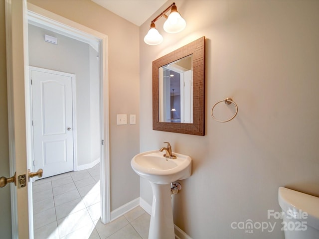 bathroom with toilet and tile patterned floors