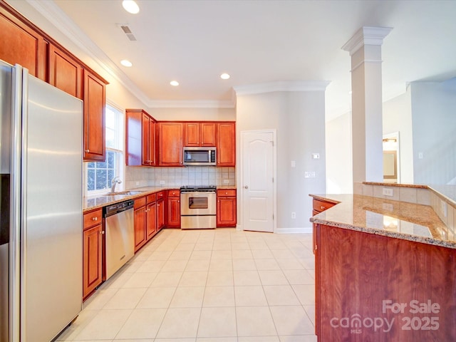 kitchen featuring kitchen peninsula, appliances with stainless steel finishes, sink, light stone countertops, and decorative backsplash