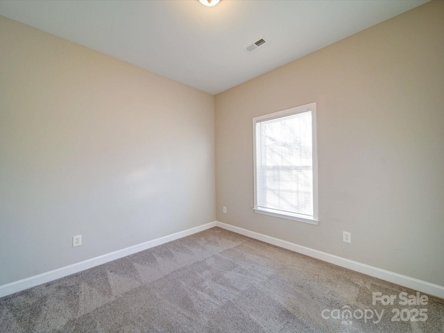 unfurnished room with light colored carpet