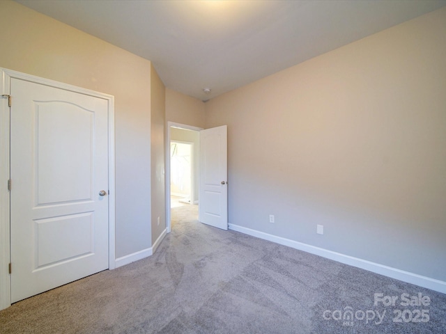 unfurnished bedroom featuring light carpet