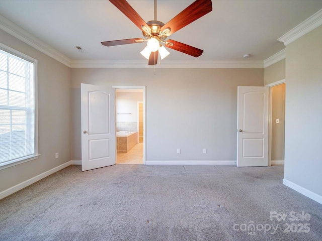 unfurnished bedroom featuring light carpet, ensuite bath, ceiling fan, and ornamental molding