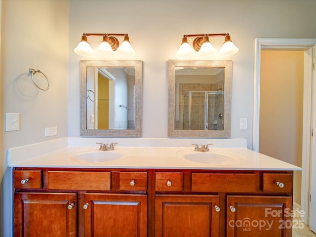 bathroom with a shower with shower door and vanity