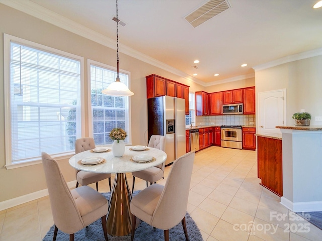 dining room with crown molding and light tile patterned flooring