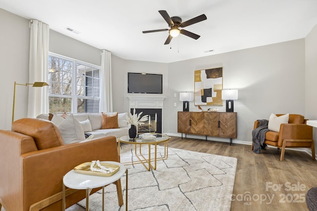 living room featuring hardwood / wood-style flooring and ceiling fan