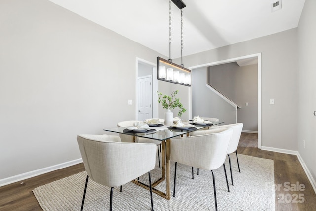 dining space featuring dark wood-type flooring