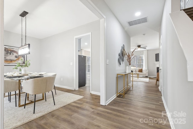 dining area featuring wood-type flooring and ceiling fan