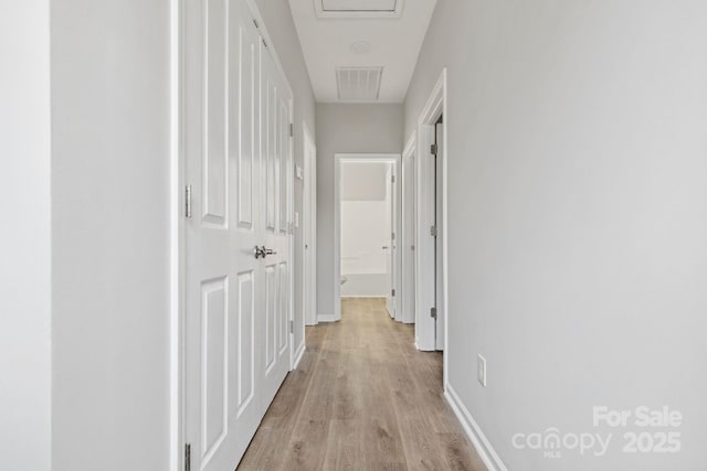 corridor featuring light hardwood / wood-style floors