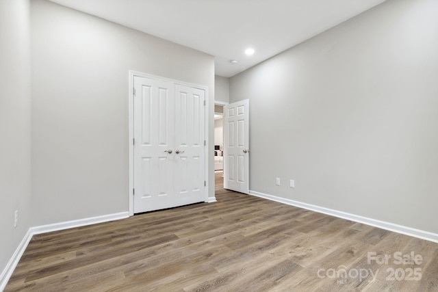 unfurnished room with hardwood / wood-style floors