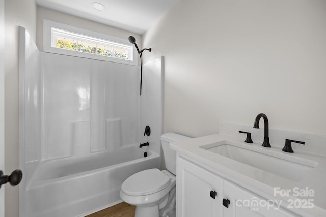 full bathroom with vanity, wood-type flooring, tub / shower combination, and toilet