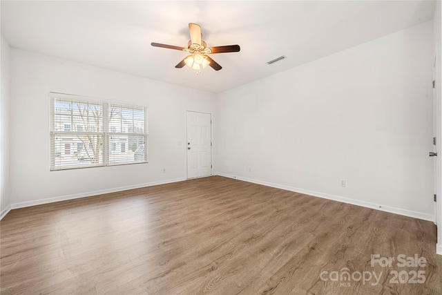 empty room with light hardwood / wood-style flooring and ceiling fan