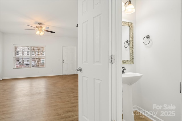 bathroom with wood-type flooring and ceiling fan