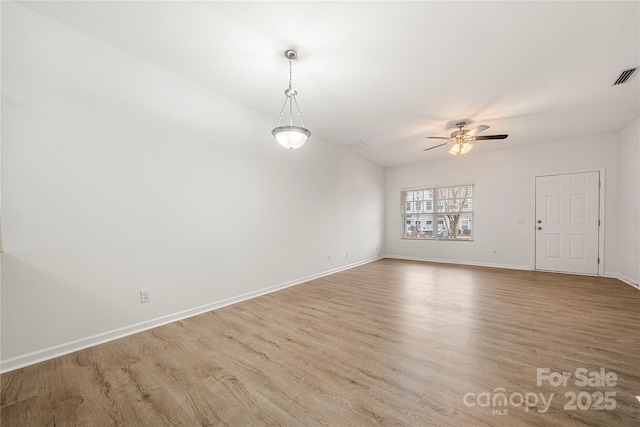 unfurnished room featuring light wood-type flooring and ceiling fan