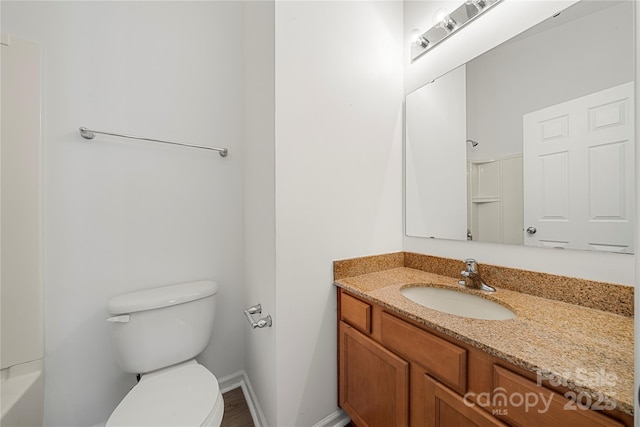 bathroom with vanity, toilet, and walk in shower