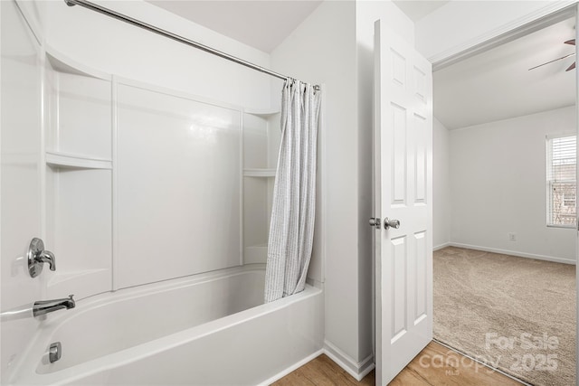 bathroom featuring ceiling fan and shower / tub combo with curtain