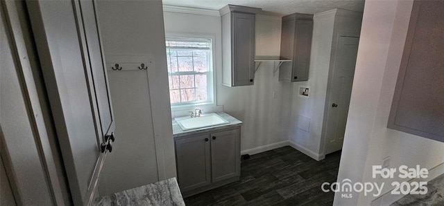 bathroom featuring hardwood / wood-style flooring, vanity, crown molding, and a textured ceiling