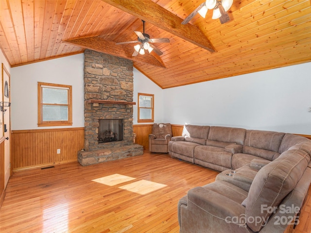 living room with ceiling fan, wooden ceiling, vaulted ceiling with beams, a fireplace, and light wood-type flooring