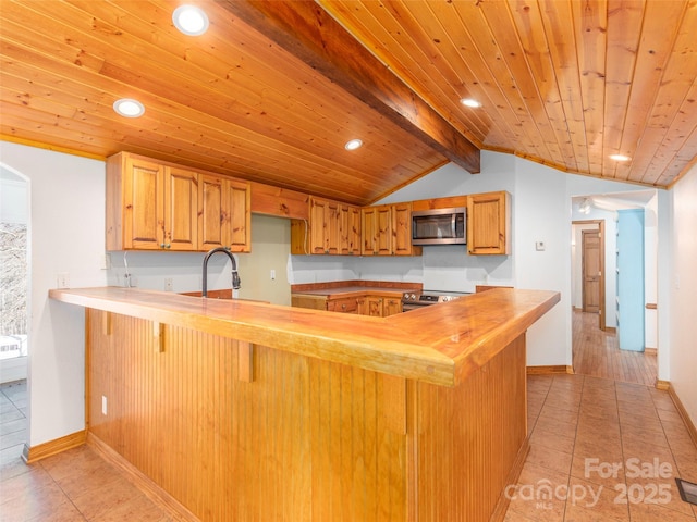 kitchen featuring kitchen peninsula, appliances with stainless steel finishes, light tile patterned floors, lofted ceiling with beams, and wooden ceiling