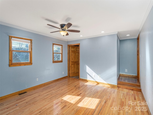 spare room with light hardwood / wood-style floors, ceiling fan, and crown molding