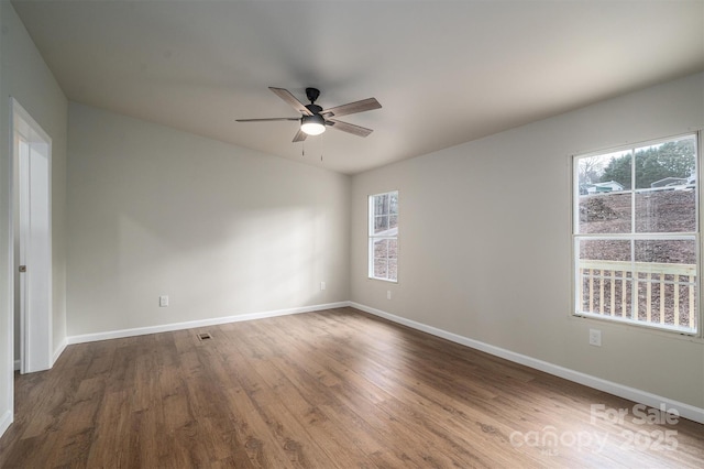 spare room featuring hardwood / wood-style flooring and ceiling fan