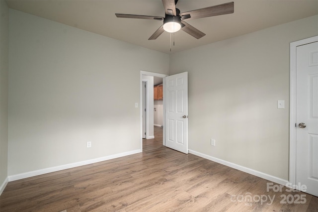 empty room featuring ceiling fan and light hardwood / wood-style flooring