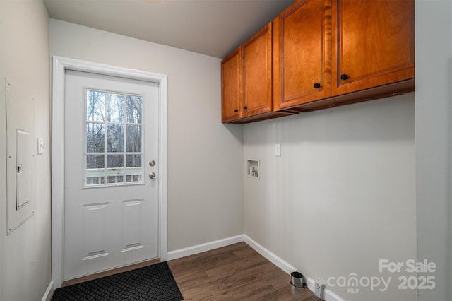 laundry room featuring dark wood-type flooring, hookup for a washing machine, and cabinets