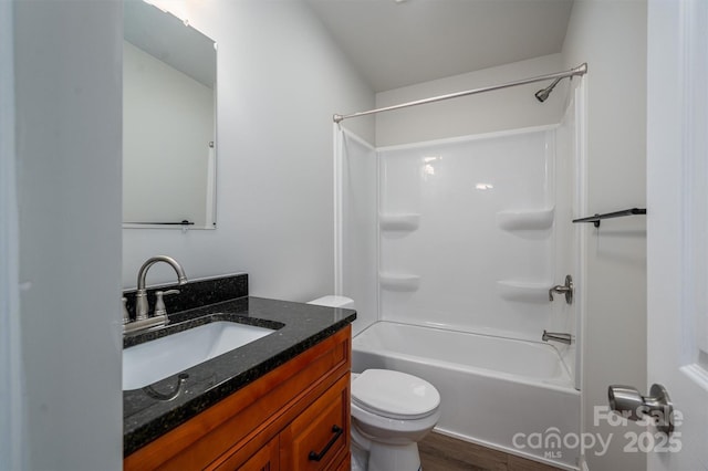 full bathroom with toilet, vanity, wood-type flooring, and tub / shower combination