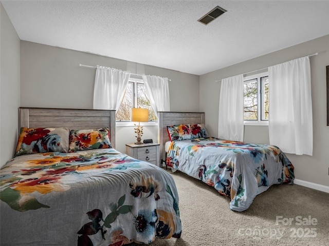 carpeted bedroom featuring a textured ceiling