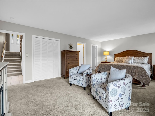 bedroom with light colored carpet and a closet