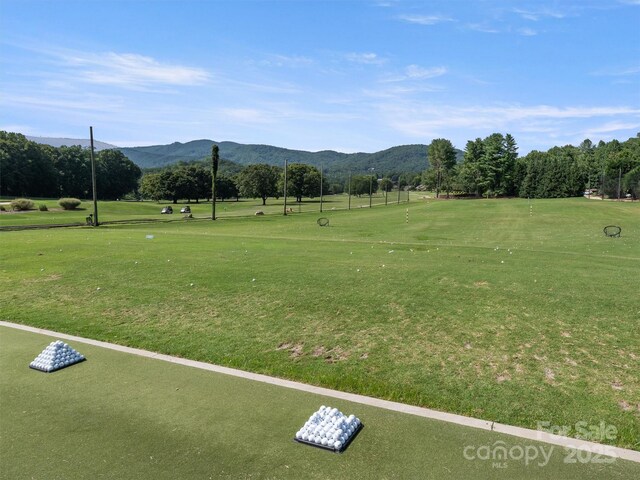 view of property's community featuring a lawn and a mountain view